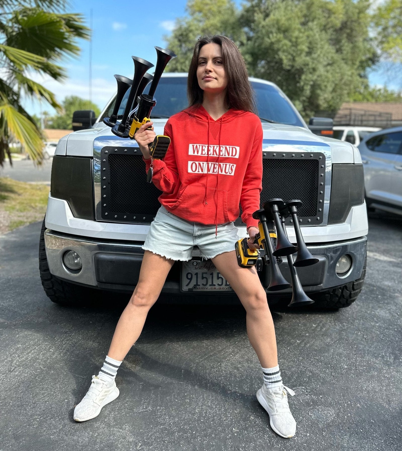 Girl holds DeWalt Train Horn in front of the Ford F150 truck - view 8