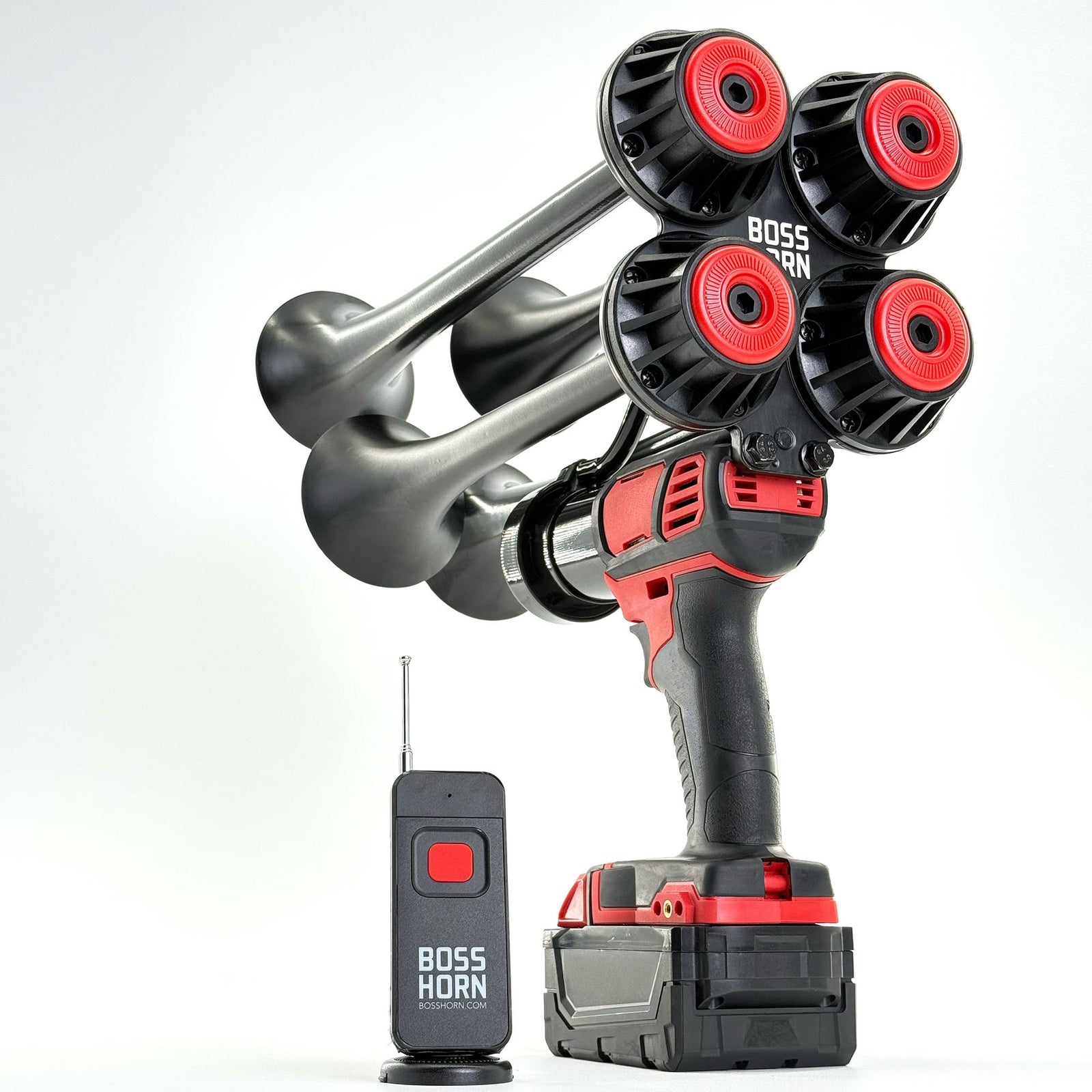 Three-quarter view of the quad-trumpet horn with red trumpet caps on a Milwaukee® M18 battery, paired with a wireless remote on white - view 11