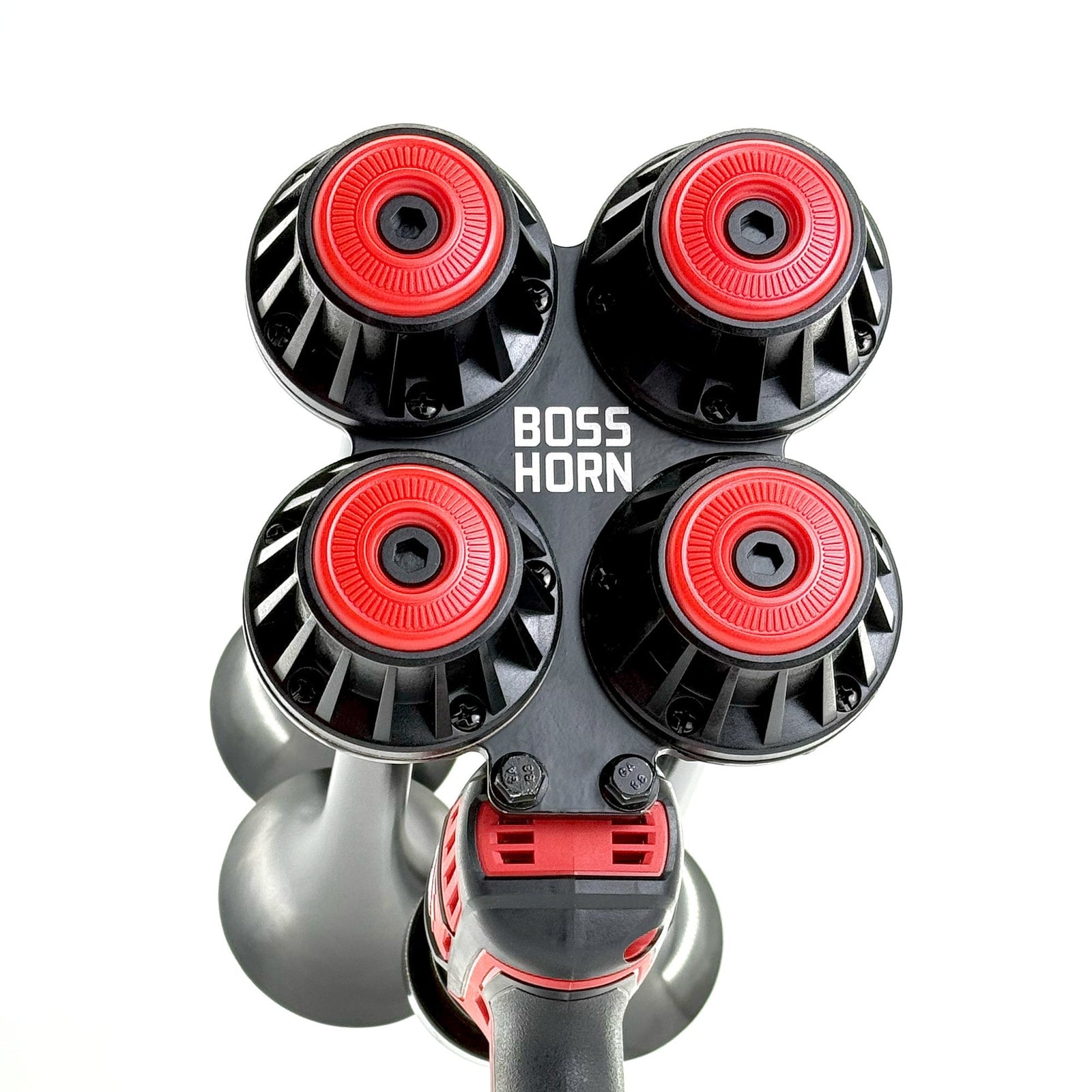 Top-down view of four black trumpets with red center caps arranged in a cluster on the horn unit against a white background - view 4