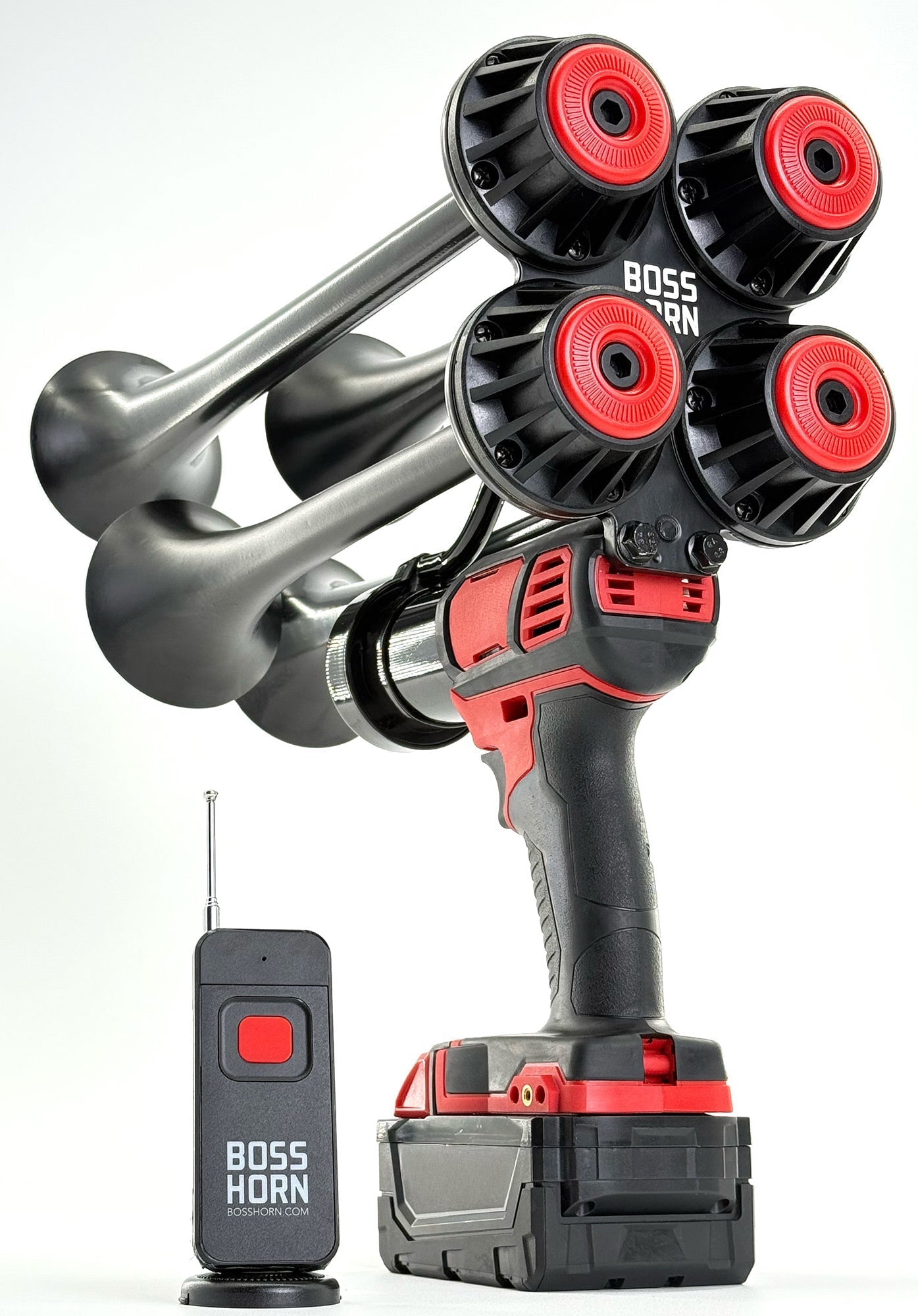 Angled studio shot of the four-trumpet train horn with red caps and curved bells, mounted on a Milwaukee® M18 battery, beside a wireless remote - view 14