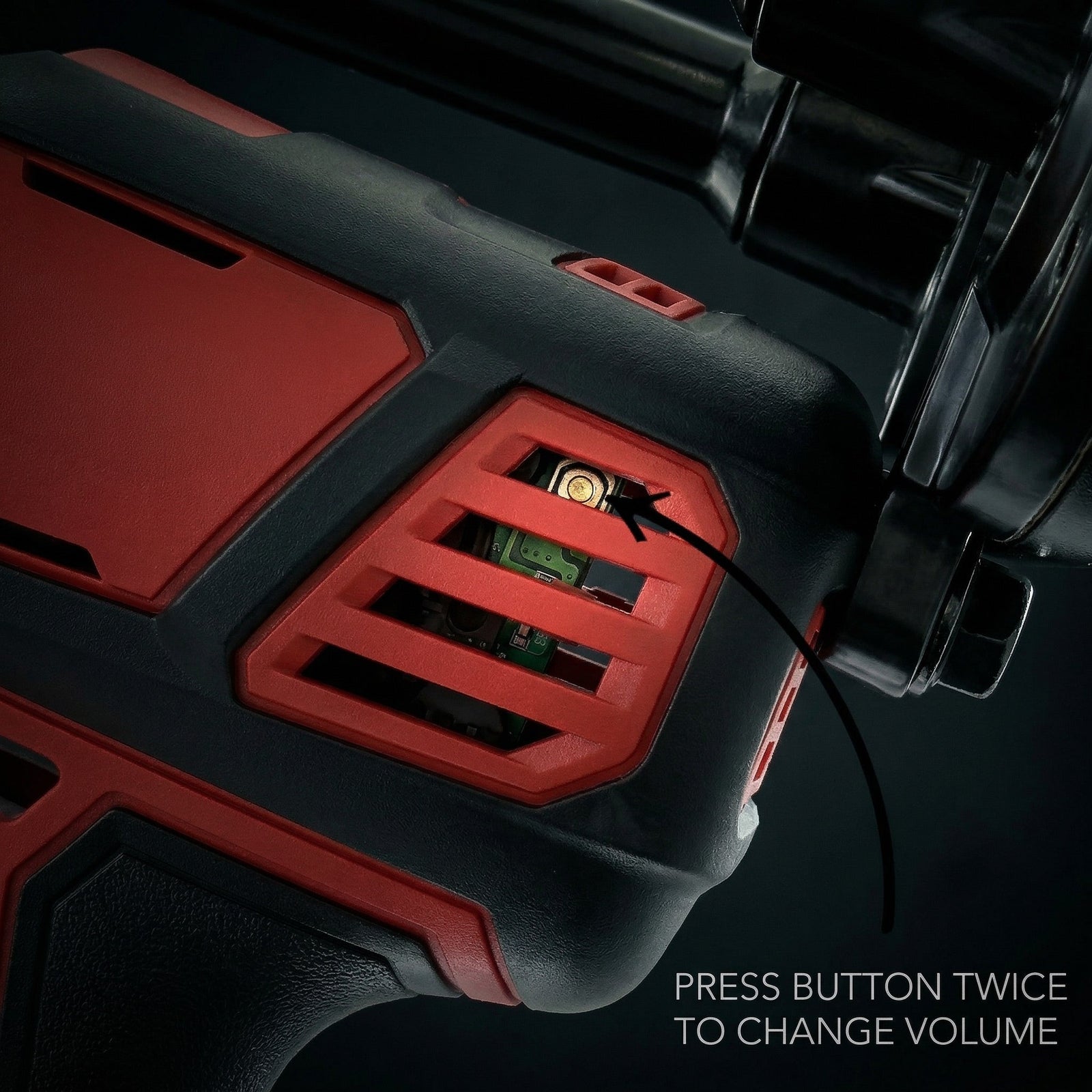 Detailed close-up of the horn's ventilated control housing showing the internal circuit and volume button on a dark backdrop - view 7